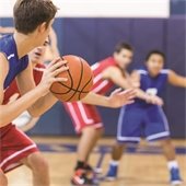 Boys playing basketball in a gym